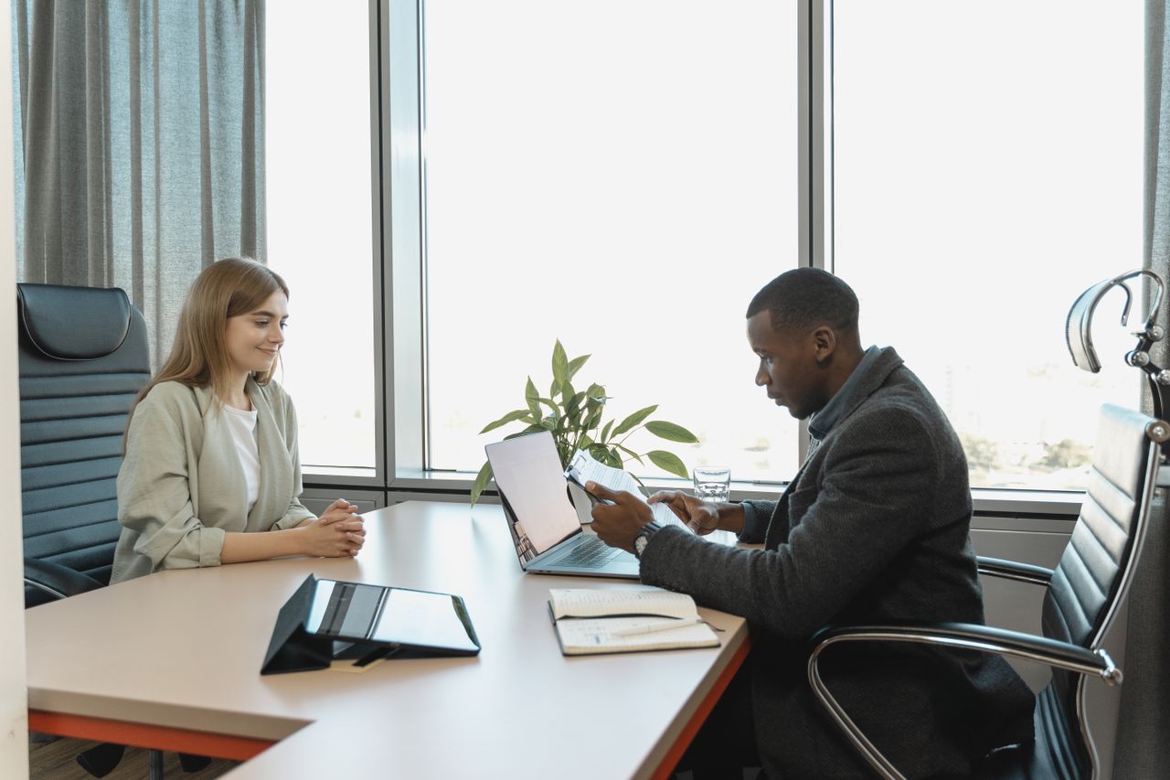 our-mission Business meeting with diverse professionals discussing a job opportunity.